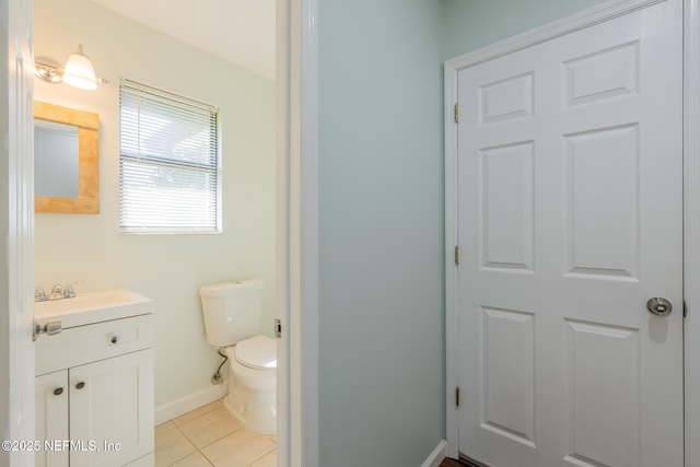 bathroom with tile patterned floors, toilet, vanity, and baseboards