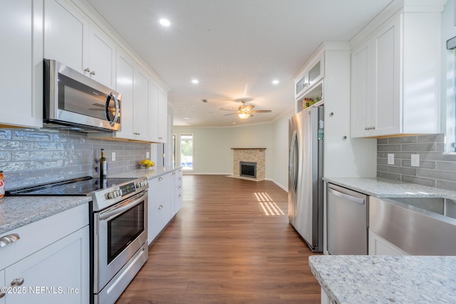 kitchen with stainless steel appliances, dark wood-style floors, open floor plan, and white cabinetry