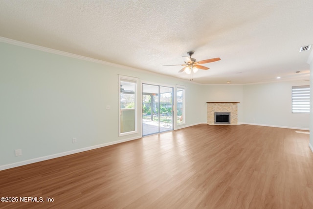 unfurnished living room with a ceiling fan, a fireplace with flush hearth, light wood-style floors, and baseboards