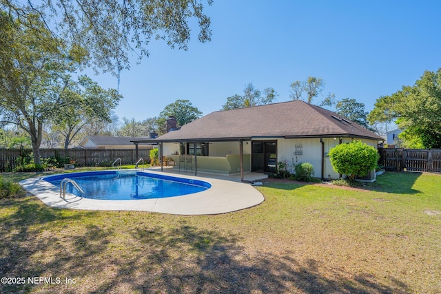 view of swimming pool featuring a patio area, a lawn, and a fenced backyard