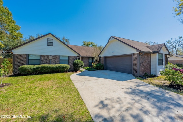 view of front facade with a front lawn, brick siding, a garage, and driveway