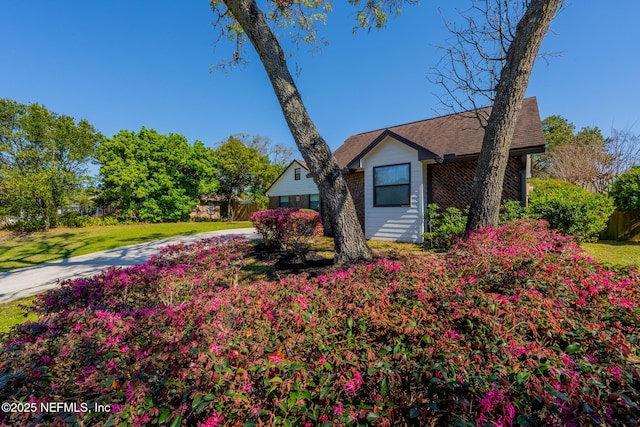 view of front of home with a front yard and fence