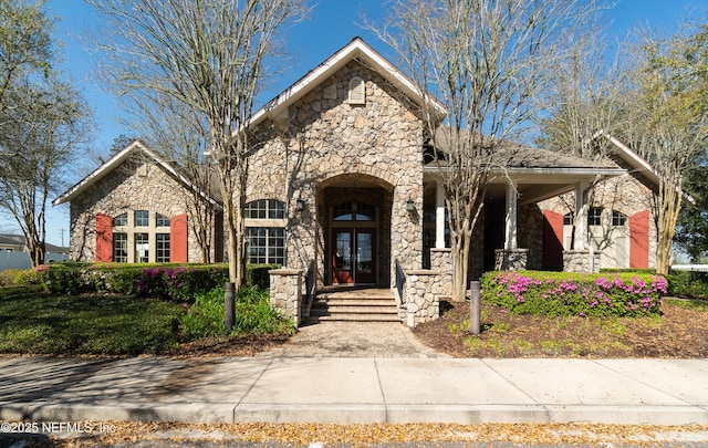 view of front of home with french doors and stone siding