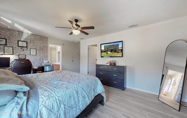 bedroom with a ceiling fan, baseboards, visible vents, and wood finish floors