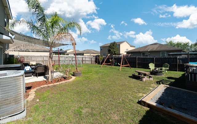 view of yard featuring a playground, cooling unit, a patio area, and a fenced backyard