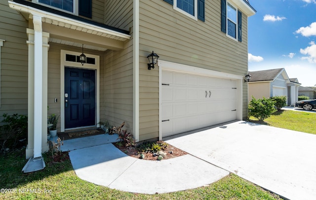 doorway to property with a garage