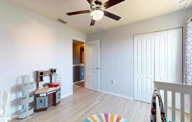 bedroom with visible vents, baseboards, ceiling fan, light wood-style flooring, and a closet