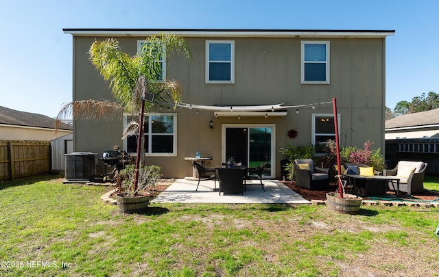 back of property with an outdoor hangout area, a lawn, fence private yard, and a patio area