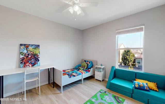 bedroom featuring baseboards, a ceiling fan, and wood finished floors