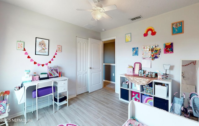 playroom with visible vents, baseboards, wood finished floors, and a ceiling fan