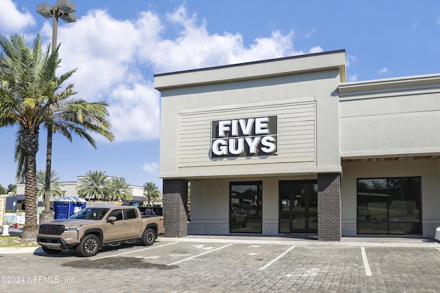 view of building exterior featuring uncovered parking