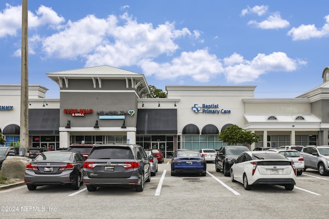 view of building exterior with uncovered parking