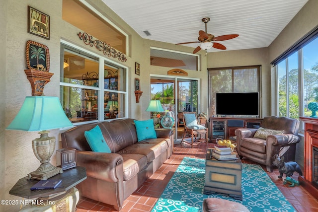 sunroom featuring visible vents and ceiling fan