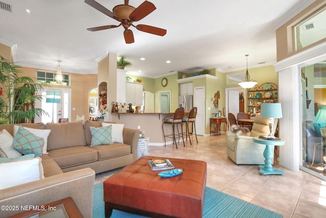 living room featuring light tile patterned floors, visible vents, ornamental molding, and recessed lighting