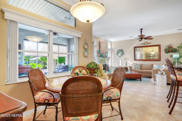 dining space featuring light tile patterned flooring and a ceiling fan