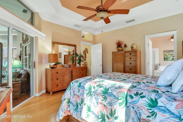 bedroom featuring light wood-type flooring, visible vents, access to outside, crown molding, and a raised ceiling