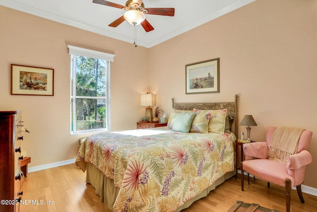 bedroom featuring ceiling fan, light wood-type flooring, baseboards, and ornamental molding