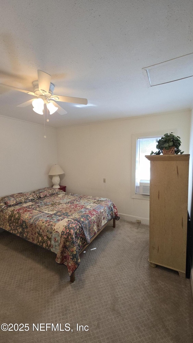 bedroom with a ceiling fan, carpet, and a textured ceiling