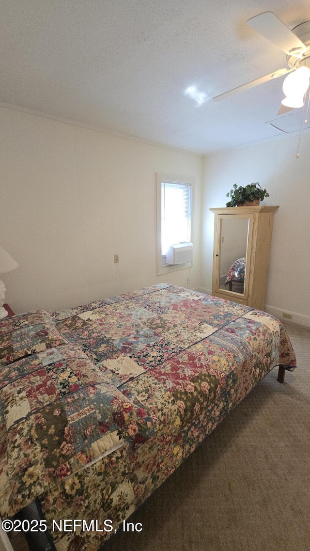 carpeted bedroom with a textured ceiling and ceiling fan