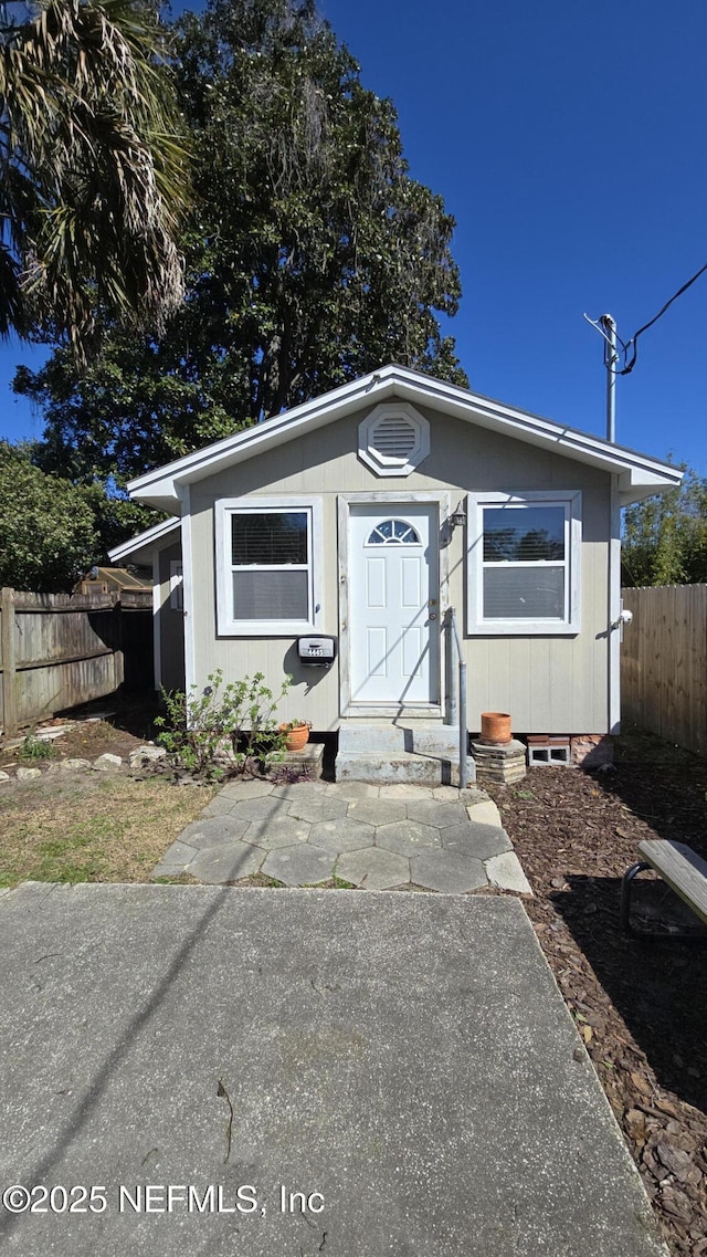 view of front of house featuring fence