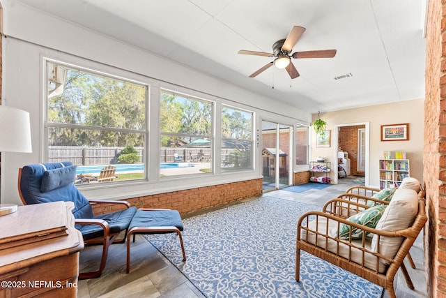 sunroom / solarium featuring a ceiling fan and visible vents