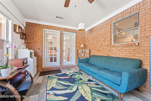 sunroom / solarium with visible vents and a ceiling fan