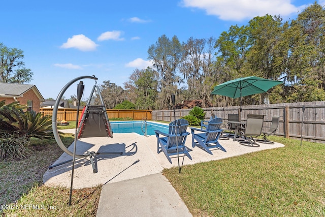 view of swimming pool with a patio, a fenced in pool, a fenced backyard, and a lawn