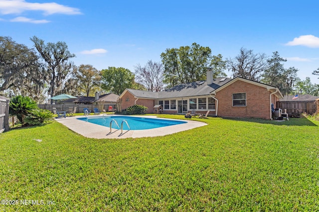 view of swimming pool with a fenced in pool, a fenced backyard, and a lawn