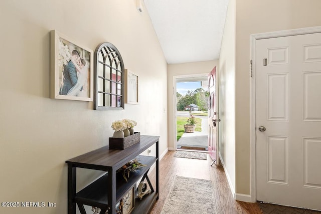 foyer entrance with wood finished floors and baseboards