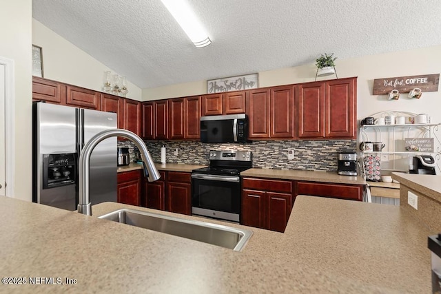 kitchen with decorative backsplash, stainless steel appliances, light countertops, and a sink