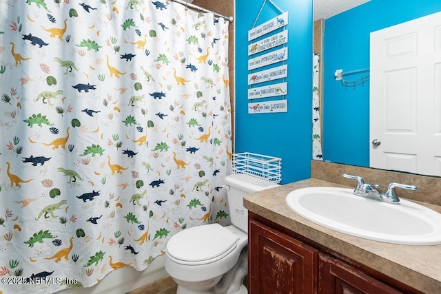 full bathroom featuring vanity, shower / tub combo, and toilet