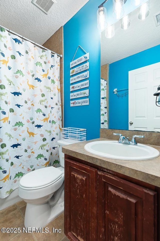 bathroom with vanity, visible vents, tile patterned flooring, a textured ceiling, and toilet