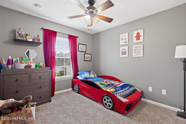 bedroom with baseboards, carpet, ceiling fan, and a textured ceiling