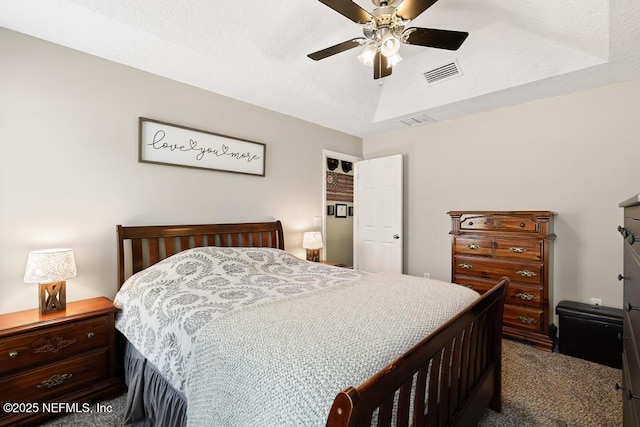 bedroom featuring visible vents, a tray ceiling, and carpet floors