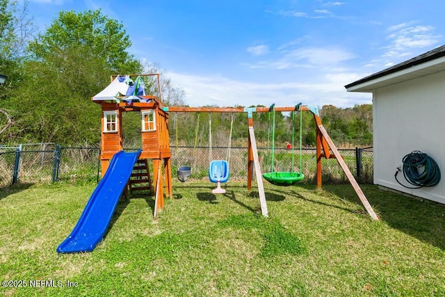 view of play area featuring a lawn and fence