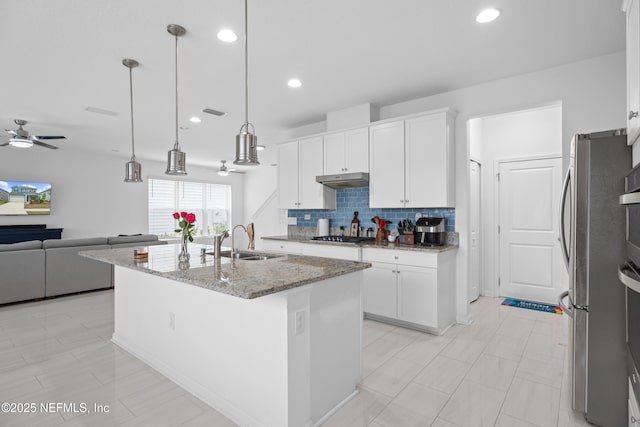 54 Ness Cir, Saint Augustine, FL 32095 - kitchen with tasteful backsplash, light stone countertops, open floor plan, appliances with stainless steel finishes, and a sink