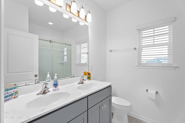 54 Ness Cir, Saint Augustine, FL 32095 - bathroom featuring double vanity, toilet, a stall shower, and a sink