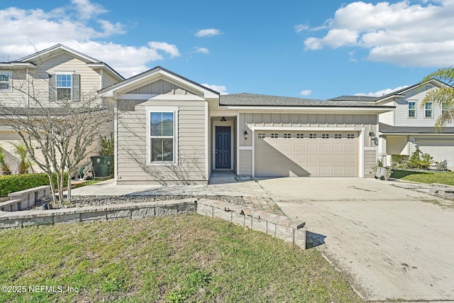 6755 Summit Vista Ct, Jacksonville, FL 32259 - view of front of home with board and batten siding, an attached garage, and driveway