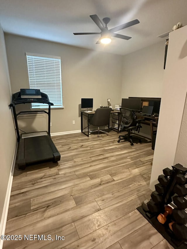 home office featuring wood finished floors, baseboards, and ceiling fan