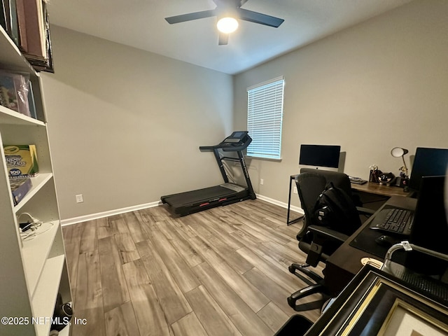 office space with a ceiling fan, wood finished floors, and baseboards