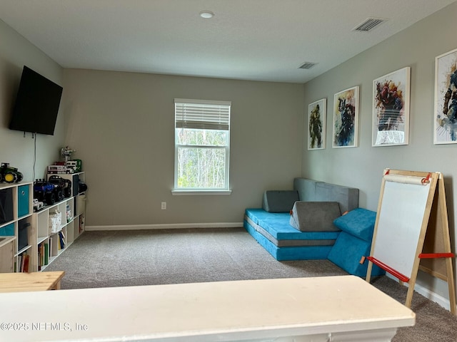 living area with visible vents, baseboards, and carpet