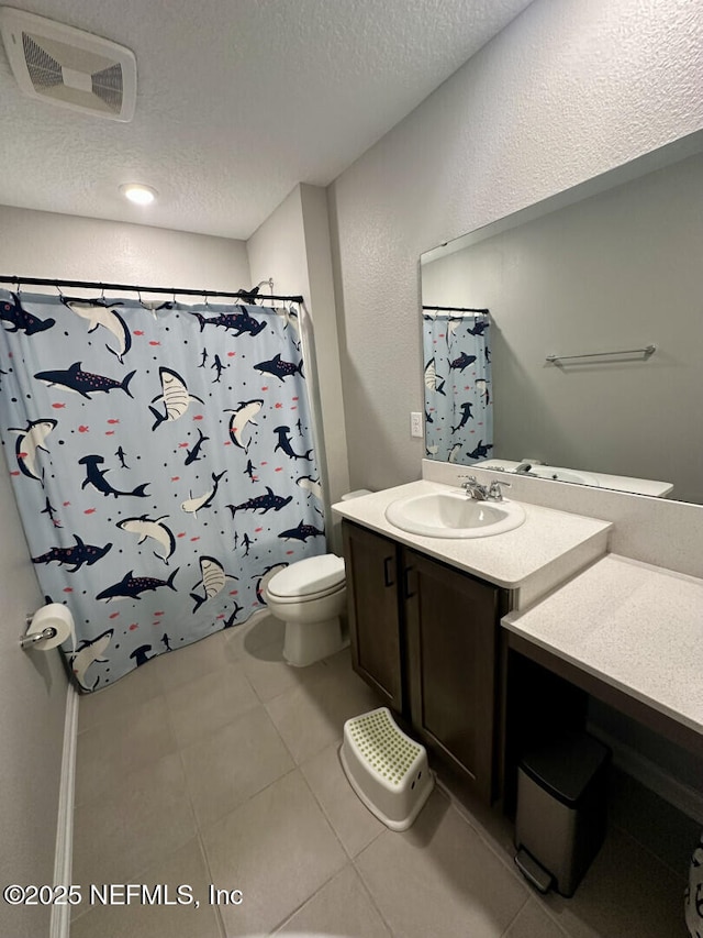 full bath featuring vanity, visible vents, a textured ceiling, tile patterned floors, and toilet