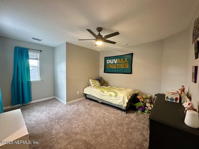 carpeted bedroom featuring baseboards, visible vents, a textured ceiling, and ceiling fan