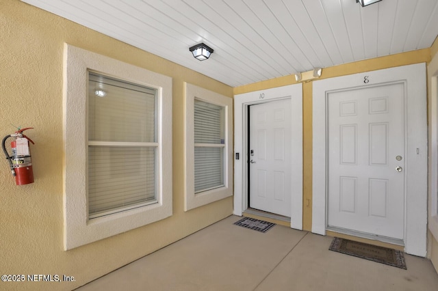 property entrance with stucco siding