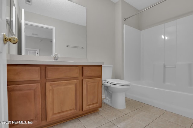 bathroom with vanity, tile patterned flooring, a textured ceiling, toilet, and shower / bathtub combination