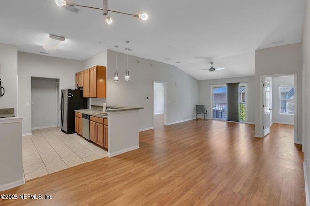 kitchen with light wood finished floors, appliances with stainless steel finishes, lofted ceiling, and a ceiling fan