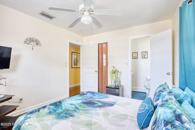 bedroom with ensuite bath, baseboards, visible vents, and ceiling fan