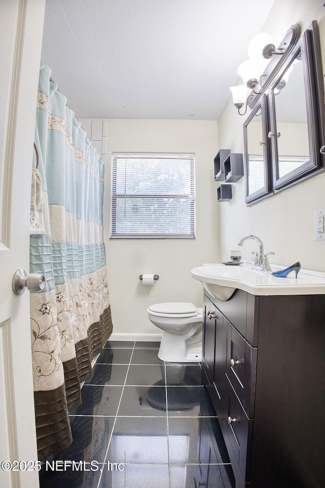 bathroom with vanity, a shower with shower curtain, baseboards, tile patterned flooring, and toilet