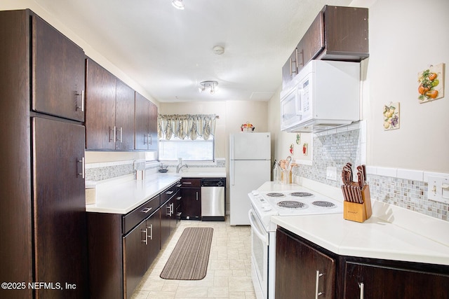 kitchen with a sink, white appliances, backsplash, and dark brown cabinetry