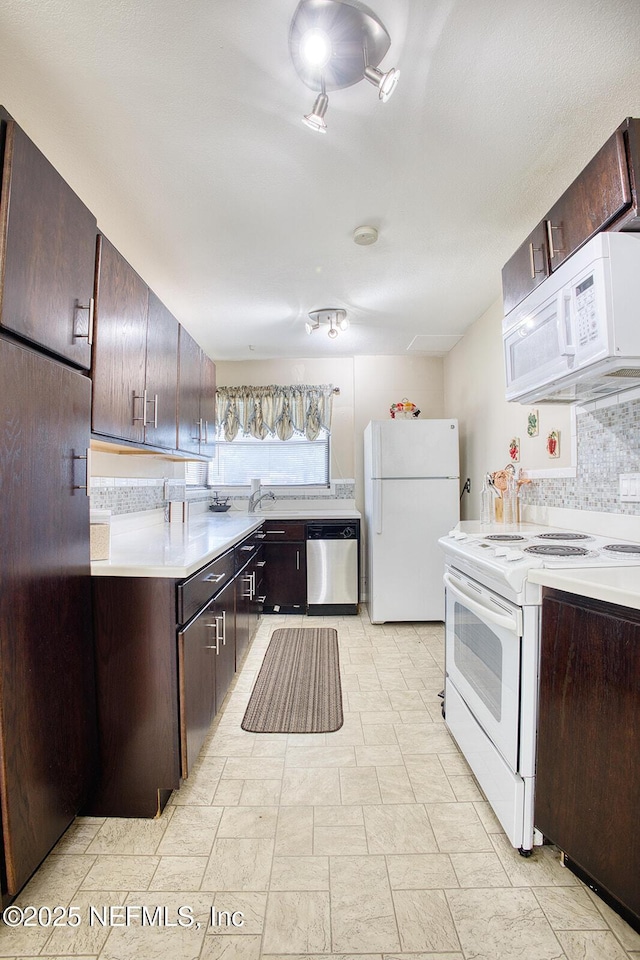 kitchen with white appliances, dark brown cabinets, light countertops, and tasteful backsplash